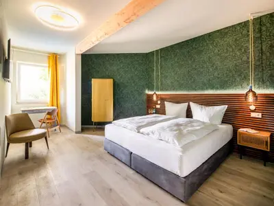 Ein Bett oder Betten in einem Zimmer der Unterkunft Stuckhotel Fettehenne