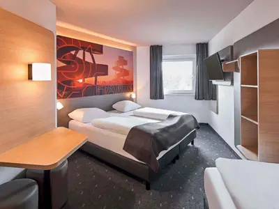 Ein Bett oder Betten in einem Zimmer der Unterkunft B&B Hotel Hamm