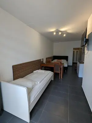 Ein Bett oder Betten in einem Zimmer der Unterkunft Hotel Mettmann