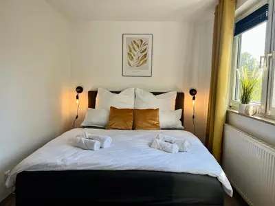 Ein Bett oder Betten in einem Zimmer der Unterkunft Design Apartment, Küche, Smart-TV, WLAN