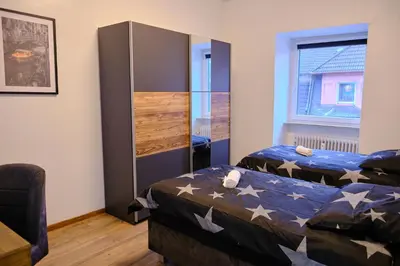 Ein Bett oder Betten in einem Zimmer der Unterkunft PrimeTime Suite für 8+Küche/WIFI
