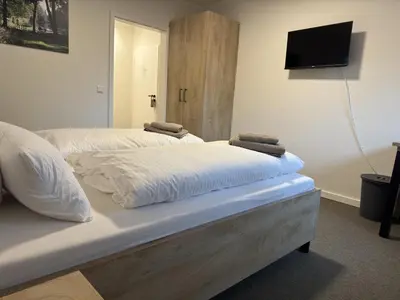 Ein Bett oder Betten in einem Zimmer der Unterkunft Gästehaus am Tiergarten