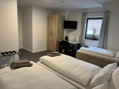 Ein Bett oder Betten in einem Zimmer der Unterkunft Gästehaus am Tiergarten