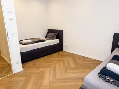 Ein Bett oder Betten in einem Zimmer der Unterkunft Ruhr Business Apartments Essen Apartment mit 5 Einzelbetten Privat Parkplatz