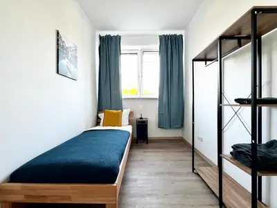 Ein Bett oder Betten in einem Zimmer der Unterkunft Aparthotel 9 min to Dus Airport & 17 min to DUS Messe