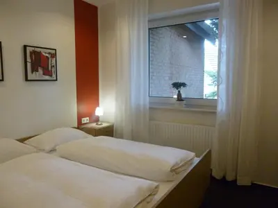Ein Bett oder Betten in einem Zimmer der Unterkunft Hotel van Lendt garni