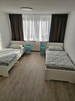 Ein Bett oder Betten in einem Zimmer der Unterkunft Helle und ruhige Ferienwohnung im Ruhrgebiet mit Balkon und Garten