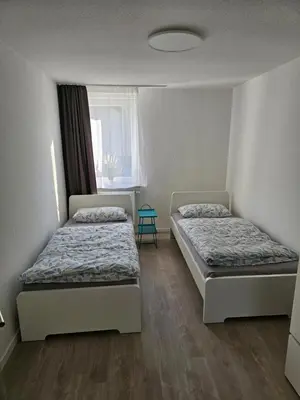 Ein Bett oder Betten in einem Zimmer der Unterkunft Helle und ruhige Ferienwohnung im Ruhrgebiet mit Balkon und Garten