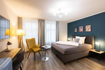 Ein Bett oder Betten in einem Zimmer der Unterkunft Hotel Stadt Lüdenscheid, Domizil Herzogstraße