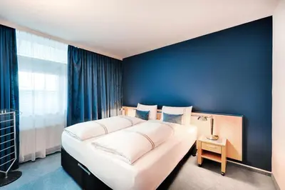 Ein Bett oder Betten in einem Zimmer der Unterkunft acom Apartments Essen