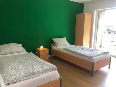 Ein Bett oder Betten in einem Zimmer der Unterkunft 3 Schlafzimmer und überdachtem Südbalkon in Haltern