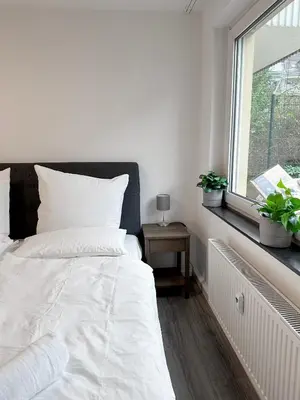Ein Bett oder Betten in einem Zimmer der Unterkunft City Apartments Essen for up to 6 person with 4K TV and kitchen
