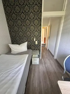 Ein Bett oder Betten in einem Zimmer der Unterkunft Bach's Restaurant Bar Hotel