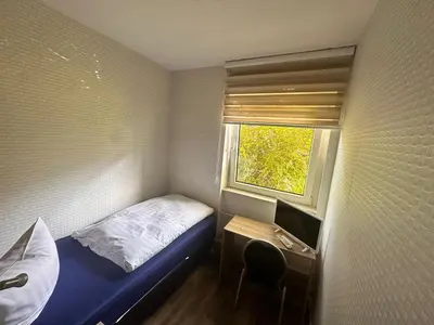 Ein Bett oder Betten in einem Zimmer der Unterkunft Bach's Restaurant Bar Hotel