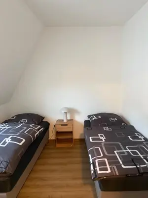 Ein Bett oder Betten in einem Zimmer der Unterkunft Über den Dächern von Werne - Balkon, WLAN, TV und Küche - Möller