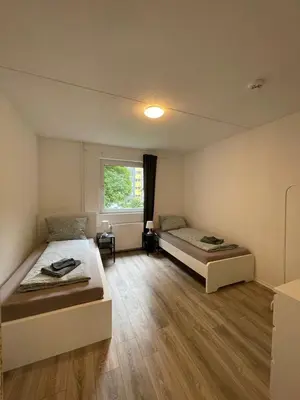 Ein Bett oder Betten in einem Zimmer der Unterkunft Gemütliches Apartment in Wuppertal Ronsdorf mit Balkon