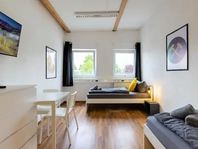 Ein Bett oder Betten in einem Zimmer der Unterkunft XXL Worker Place Herne