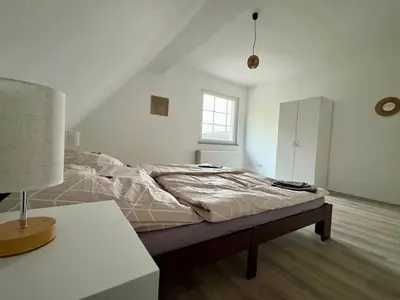 Ein Bett oder Betten in einem Zimmer der Unterkunft Komfort & Stil, Moderne Wohnung mit Fitnessraum