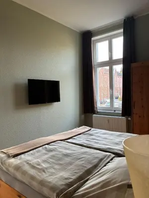 Ein Bett oder Betten in einem Zimmer der Unterkunft Gästehaus LeLo 5