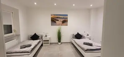 Ein Bett oder Betten in einem Zimmer der Unterkunft Gästehaus Hagen 6 Betten, Parkplatz, Küche, WLAN Easybooking24