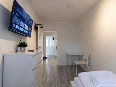 TV/Unterhaltungsangebot in der Unterkunft BudgetRoom Modernes Apartment mit 3 Schlafzimmern