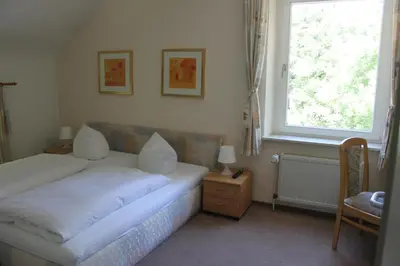 Ein Bett oder Betten in einem Zimmer der Unterkunft Hotel Bergische Schweiz