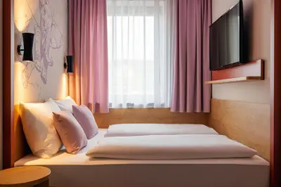 Ein Bett oder Betten in einem Zimmer der Unterkunft McDreams Hotel Wuppertal City