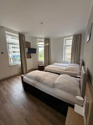 Ein Bett oder Betten in einem Zimmer der Unterkunft Central Hotel Duisburg