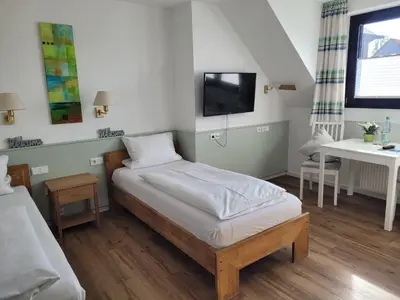 Ein Bett oder Betten in einem Zimmer der Unterkunft Hotel Wolfsjäger