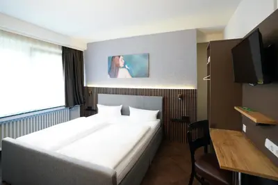Ein Bett oder Betten in einem Zimmer der Unterkunft Hotel Frohnhauser Hof