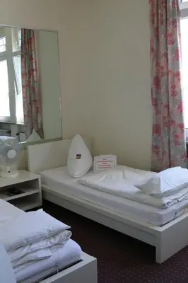 Ein Bett oder Betten in einem Zimmer der Unterkunft Hotel Moerser Hof