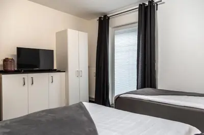 Ein Bett oder Betten in einem Zimmer der Unterkunft Aparthotel Menden