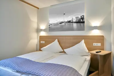 Ein Bett oder Betten in einem Zimmer der Unterkunft McDreams Hotel Düsseldorf-City