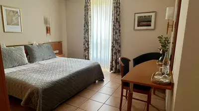 Ein Bett oder Betten in einem Zimmer der Unterkunft Hotel Victoria