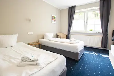 Ein Bett oder Betten in einem Zimmer der Unterkunft El Capitan nähe Movie Park