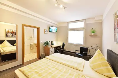 Ein Bett oder Betten in einem Zimmer der Unterkunft Hotel Haus Kleimann-Reuer