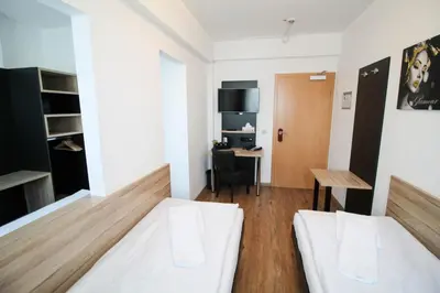 Ein Bett oder Betten in einem Zimmer der Unterkunft Center Hotel Essen