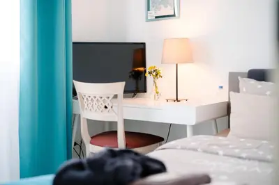 Ein Bett oder Betten in einem Zimmer der Unterkunft GästeHaus am Flughafen Düsseldorf
