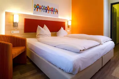 Ein Bett oder Betten in einem Zimmer der Unterkunft Hotel am Stadtpark