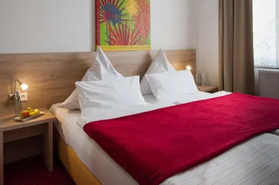 Ein Bett oder Betten in einem Zimmer der Unterkunft Hotel König