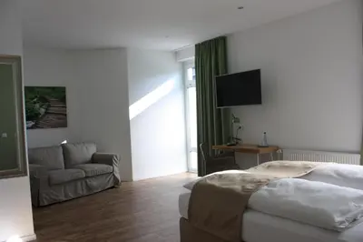 Ein Bett oder Betten in einem Zimmer der Unterkunft Hotel Grüner Baum