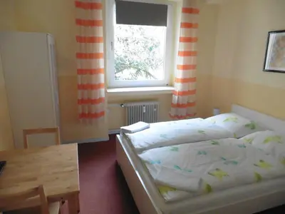 Ein Bett oder Betten in einem Zimmer der Unterkunft Gästehaus Grupello