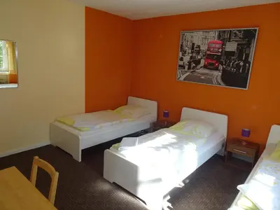 Ein Bett oder Betten in einem Zimmer der Unterkunft Gästehaus Grupello
