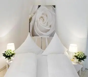 Ein Bett oder Betten in einem Zimmer der Unterkunft Hotel Villa Falkenberg