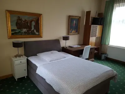 Ein Bett oder Betten in einem Zimmer der Unterkunft Schillers Hotel & Café - GARNI -