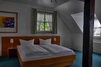 Ein Bett oder Betten in einem Zimmer der Unterkunft Hotel Alte Linden