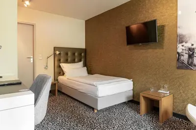 Ein Bett oder Betten in einem Zimmer der Unterkunft Hotel An der Gruga