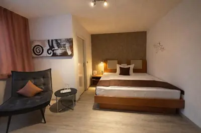 Ein Bett oder Betten in einem Zimmer der Unterkunft Arena Hotel