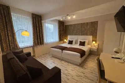 Ein Bett oder Betten in einem Zimmer der Unterkunft Arena Hotel
