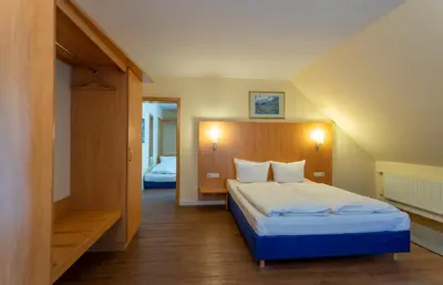 Ein Bett oder Betten in einem Zimmer der Unterkunft Waldhotel Eskeshof